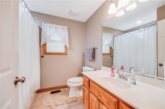 full bath featuring toilet, vanity, tile patterned floors, and baseboards