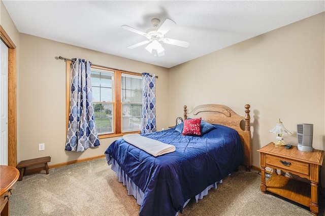 carpeted bedroom featuring baseboards and ceiling fan