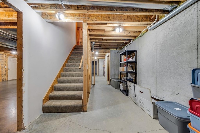 unfinished basement featuring stairway