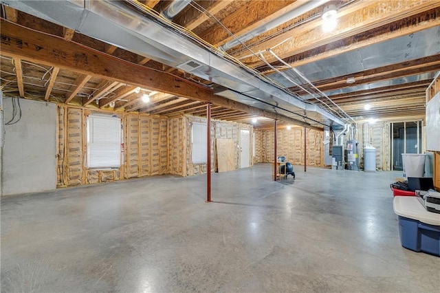 unfinished below grade area featuring water heater