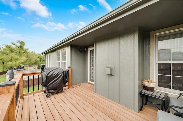 wooden deck featuring a grill