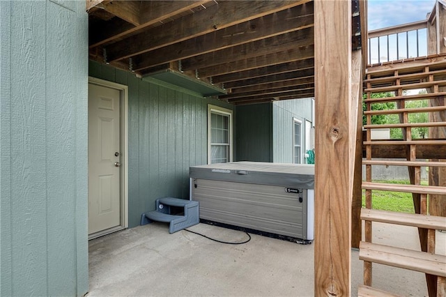 entrance to property featuring a hot tub and a patio
