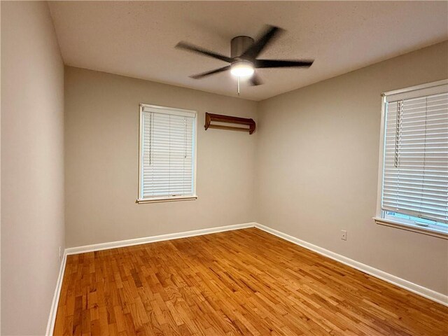 406 Bowen St, Linwood, KS 66052 - unfurnished room with light wood finished floors, ceiling fan, and baseboards