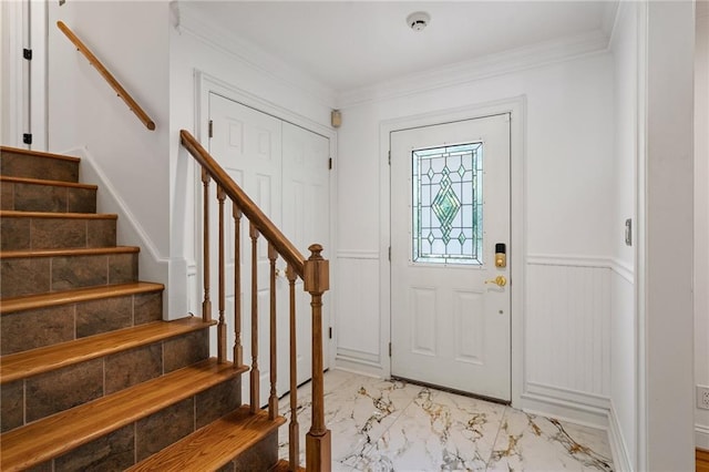 8822 Hadley St, Overland Park, KS 66212 - entryway with light marble finish flooring, stairs, wainscoting, ornamental molding, and a decorative wall