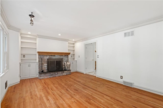8822 Hadley St, Overland Park, KS 66212 - unfurnished living room with crown molding, light wood-style floors, a fireplace, recessed lighting, and built in shelves
