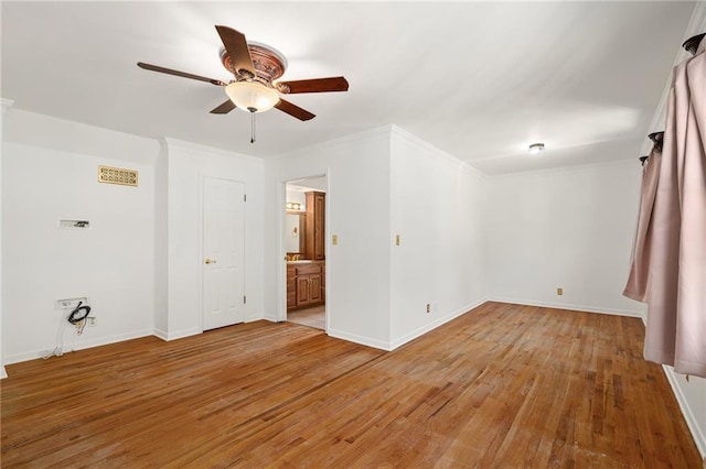 8822 Hadley St, Overland Park, KS 66212 - spare room featuring light wood-style floors, a ceiling fan, and crown molding