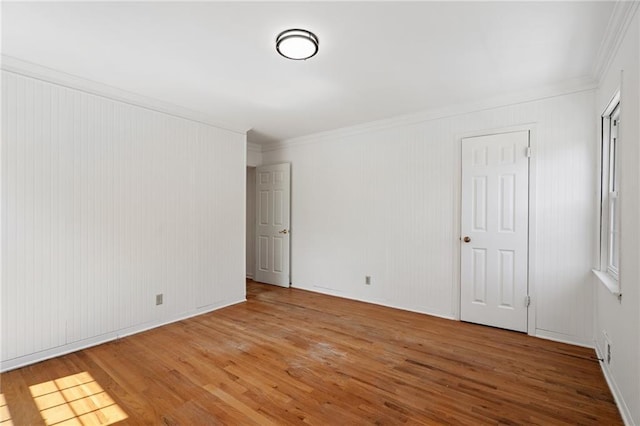 8822 Hadley St, Overland Park, KS 66212 - spare room with wood finished floors and ornamental molding