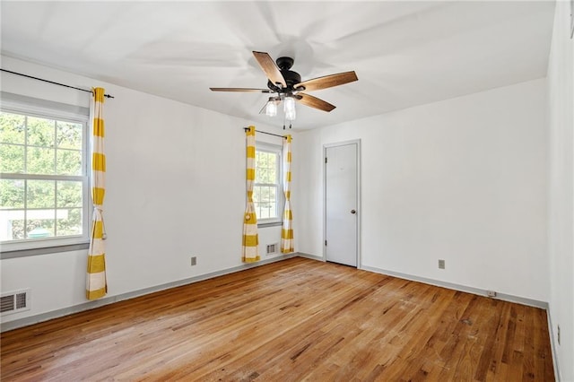 8822 Hadley St, Overland Park, KS 66212 - empty room with healthy amount of natural light, wood finished floors, and a ceiling fan