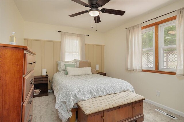 906 W Pearl St, Savannah, MO 64485 - bedroom with light colored carpet, multiple windows, and ceiling fan