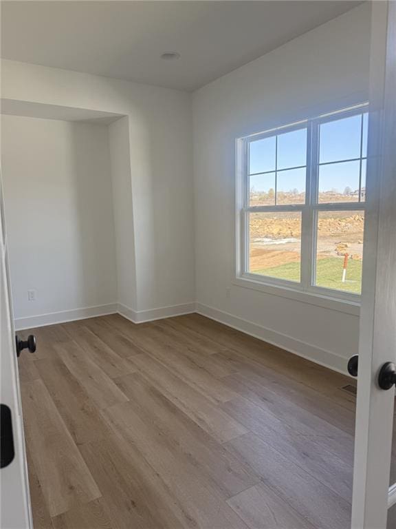 8913 N Colorado Ave, Kansas City, MO 64156 - spare room featuring wood finished floors and baseboards
