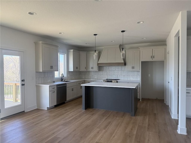 8913 N Colorado Ave, Kansas City, MO 64156 - kitchen with custom range hood, dishwasher, light countertops, light wood-style floors, and recessed lighting