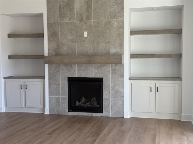8913 N Colorado Ave, Kansas City, MO 64156 - detailed view of wood finished floors, a fireplace, and built in features