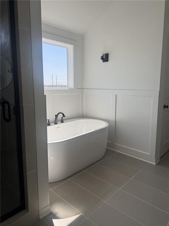 8913 N Colorado Ave, Kansas City, MO 64156 - full bath with a freestanding tub, tile patterned flooring, a shower stall, a decorative wall, and wainscoting