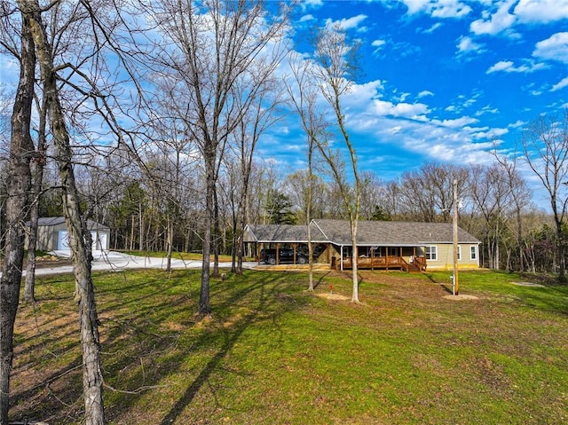 10200 SE 1075th Rd, Collins, MO 64738 - view of front facade featuring driveway, a front lawn, a garage, and a carport