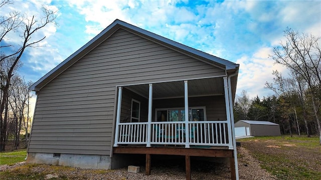 10200 SE 1075th Rd, Collins, MO 64738 - view of side of home with crawl space, an outbuilding, and covered porch