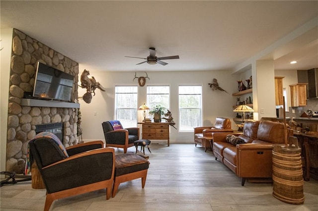 10200 SE 1075th Rd, Collins, MO 64738 - living area with ceiling fan, a fireplace, and light wood finished floors