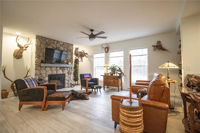 10200 SE 1075th Rd, Collins, MO 64738 - living area featuring ceiling fan, light wood-style floors, and a stone fireplace