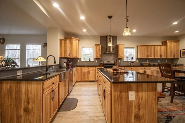 10200 SE 1075th Rd, Collins, MO 64738 - kitchen with wall chimney range hood, appliances with stainless steel finishes, recessed lighting, a sink, and healthy amount of natural light