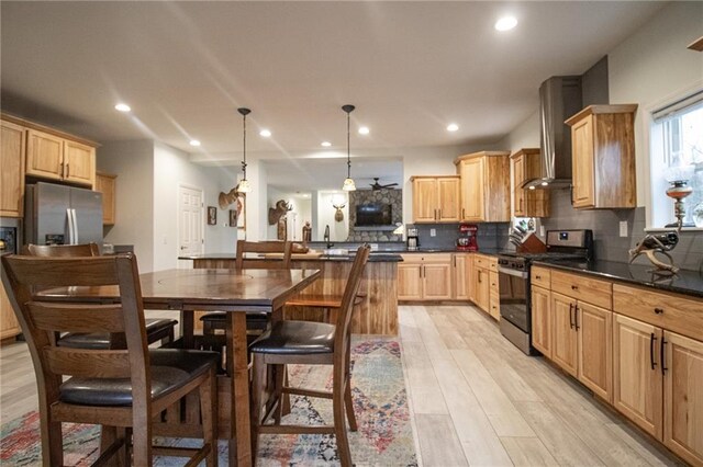 10200 SE 1075th Rd, Collins, MO 64738 - kitchen featuring appliances with stainless steel finishes, wall chimney exhaust hood, light brown cabinetry, tasteful backsplash, and recessed lighting