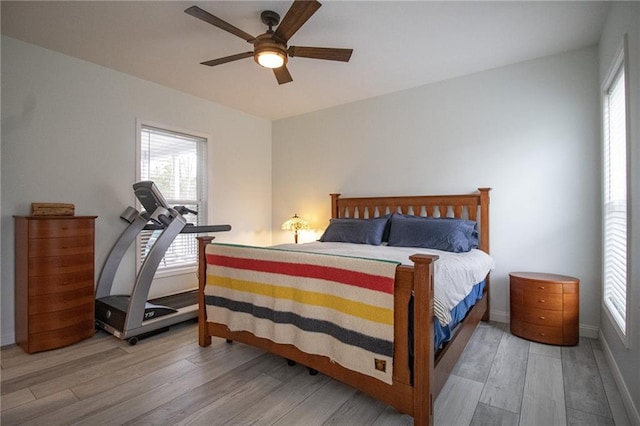 10200 SE 1075th Rd, Collins, MO 64738 - bedroom featuring wood finished floors, multiple windows, ceiling fan, and baseboards