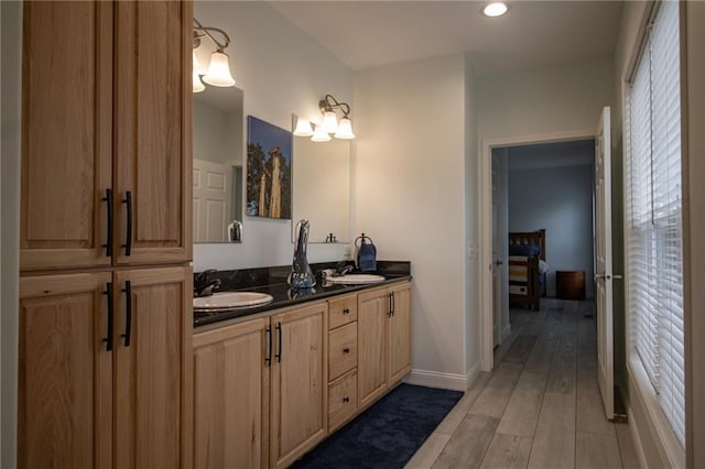 10200 SE 1075th Rd, Collins, MO 64738 - full bathroom with wood finished floors, double vanity, baseboards, and recessed lighting