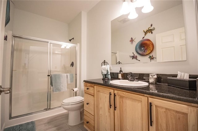 10200 SE 1075th Rd, Collins, MO 64738 - full bathroom featuring toilet, a shower stall, vanity, and wood finished floors