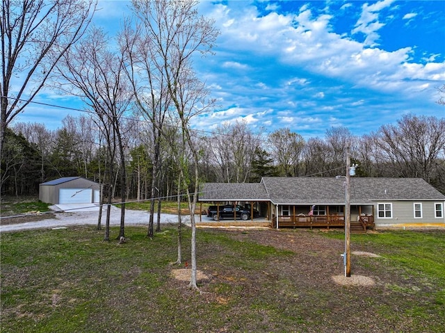 10200 SE 1075th Rd, Collins, MO 64738 - view of front of property featuring driveway, a carport, an outdoor structure, a detached garage, and a porch