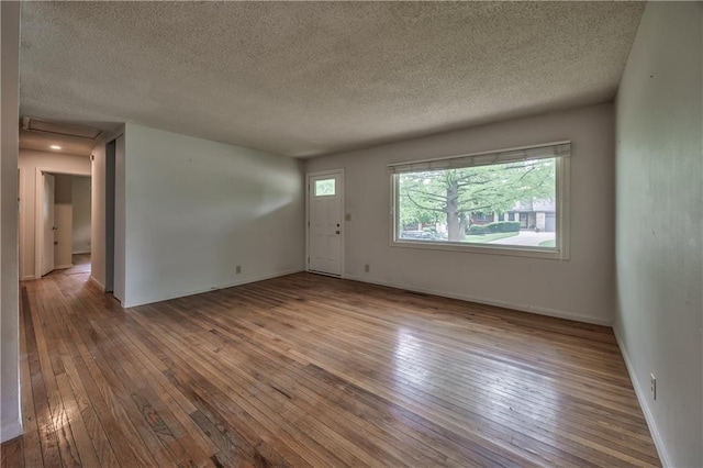 4306 W 78th Ter, Prairie Village, KS 66208 - spare room featuring hardwood / wood-style floors, a textured ceiling, and baseboards