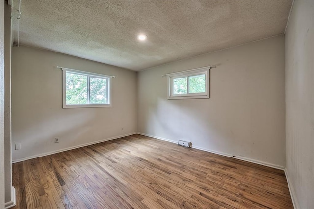 4306 W 78th Ter, Prairie Village, KS 66208 - spare room with a textured ceiling, wood finished floors, and baseboards