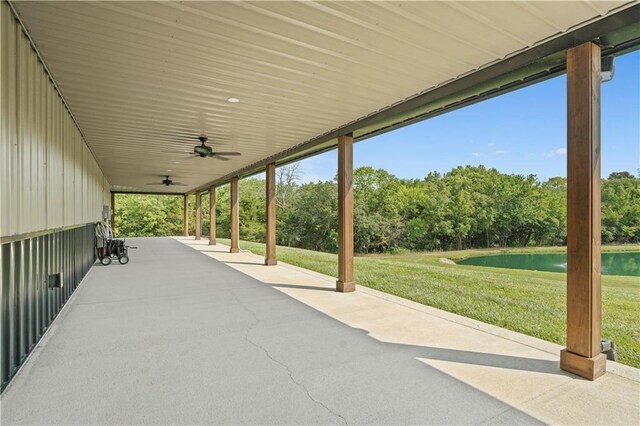 view of patio with ceiling fan and view of scattered trees