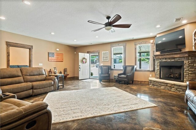 living area with plenty of natural light, a ceiling fan, a fireplace, recessed lighting, and baseboards