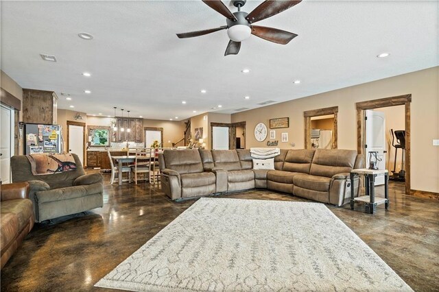 living area featuring finished concrete floors, ceiling fan, and recessed lighting