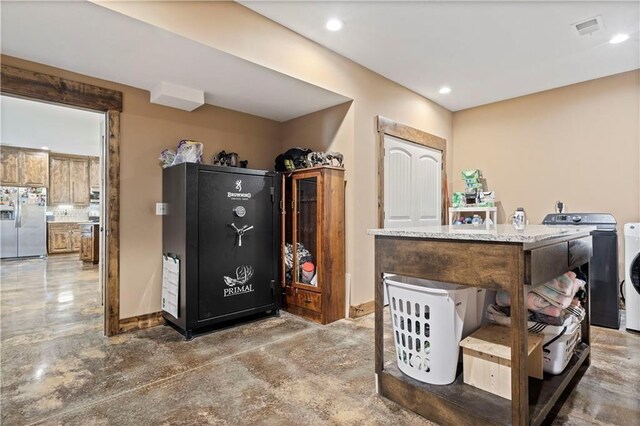 misc room featuring washer / dryer, concrete flooring, recessed lighting, and baseboards
