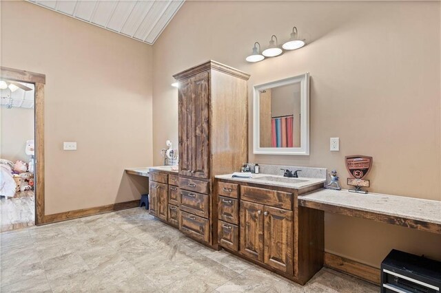 full bath featuring vanity and vaulted ceiling