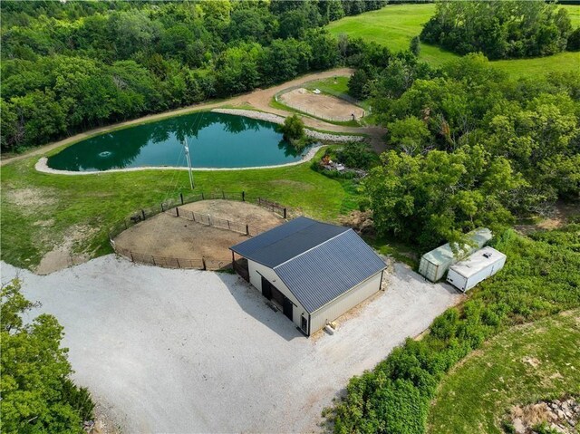 drone / aerial view of a large body of water and a heavily wooded area