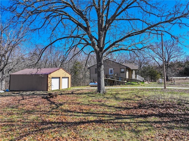 10875 SE 54th Hwy, Collins, MO 64738 - view of grassy yard featuring a detached garage and an outdoor structure