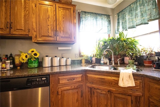 10875 SE 54th Hwy, Collins, MO 64738 - kitchen featuring stainless steel dishwasher, a sink, brown cabinets, and dark stone counters