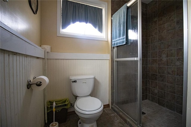 10875 SE 54th Hwy, Collins, MO 64738 - bathroom featuring a wainscoted wall, a shower stall, and toilet