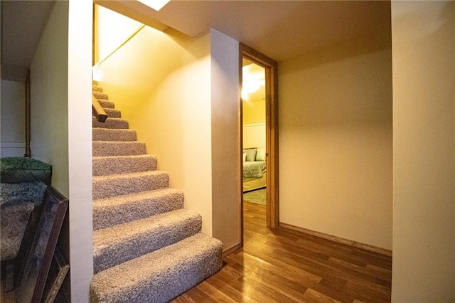 10875 SE 54th Hwy, Collins, MO 64738 - stairway featuring wood finished floors and baseboards