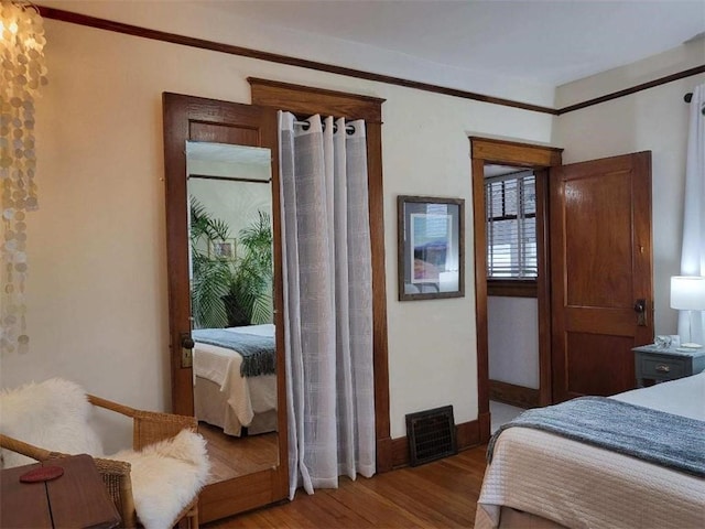 bedroom featuring wood finished floors and baseboards