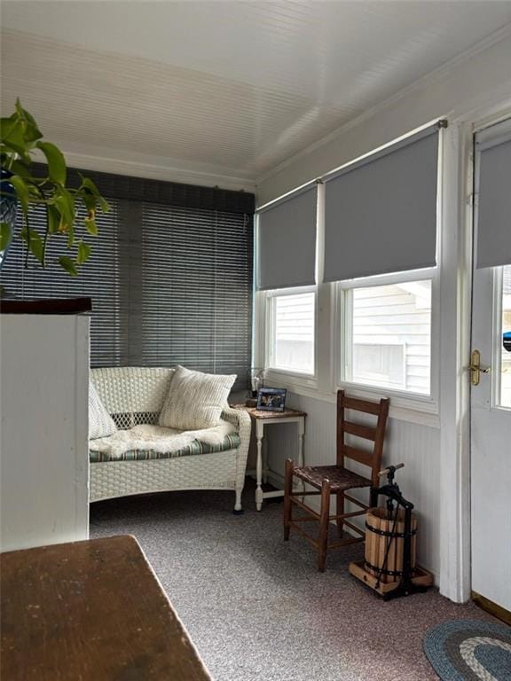 living room featuring healthy amount of natural light, carpet flooring, and ornamental molding