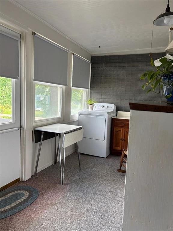 clothes washing area with washer / clothes dryer, healthy amount of natural light, and crown molding