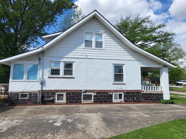 view of property exterior with a porch