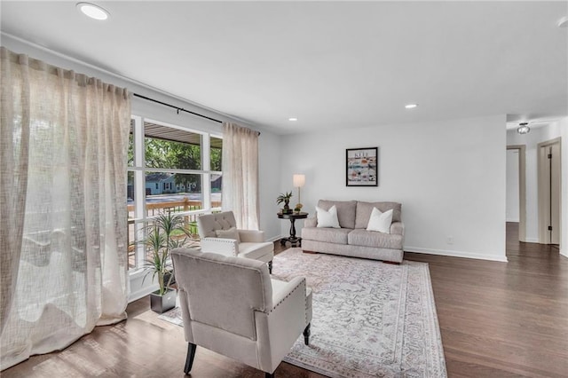 living area with wood finished floors, baseboards, and recessed lighting