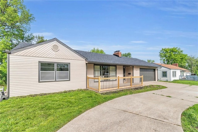 3710 S Sterling Ave, Independence, MO 64052 - single story home featuring a porch, driveway, a front lawn, an attached garage, and a chimney