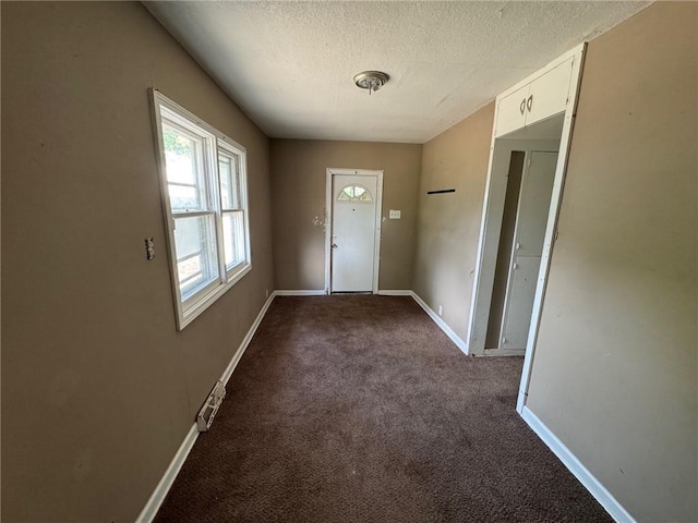 2544 S Overton Ave, Independence, MO 64052 - doorway to outside with carpet flooring, a textured ceiling, and baseboards