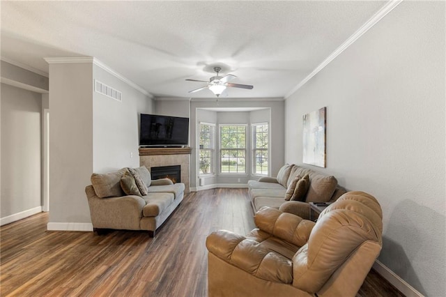 14037 W 112th Ter, Olathe, KS 66062 - living room featuring wood finished floors, baseboards, ornamental molding, ceiling fan, and a tiled fireplace