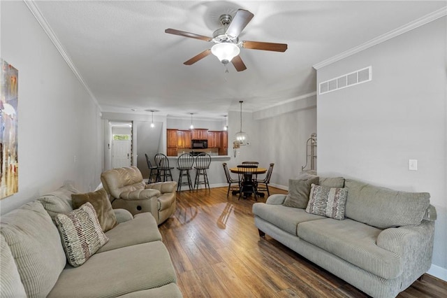 14037 W 112th Ter, Olathe, KS 66062 - living room with ceiling fan, wood finished floors, ornamental molding, and baseboards