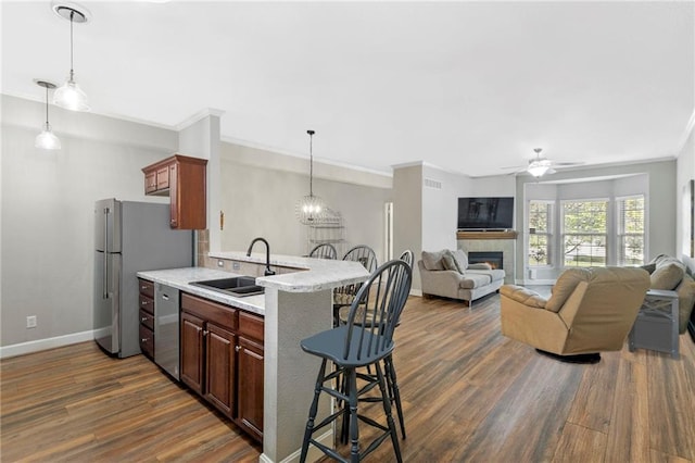 14037 W 112th Ter, Olathe, KS 66062 - kitchen featuring a sink, stainless steel dishwasher, a kitchen breakfast bar, light countertops, and freestanding refrigerator