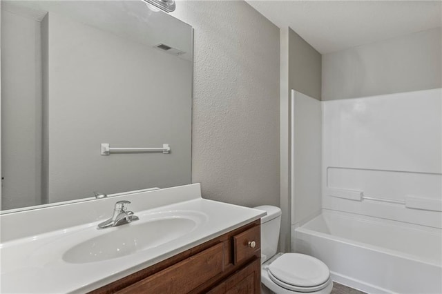 14037 W 112th Ter, Olathe, KS 66062 - full bath featuring toilet, vanity, a textured wall, and shower / bath combination
